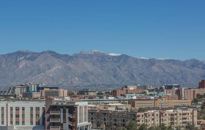 a large building with a mountain in the background