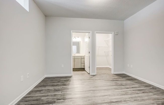 a bedroom with gray walls and a wooden floor at Century University City, Charlotte, 28213