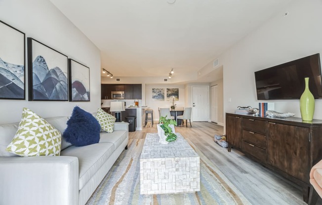 a living room with a couch and a coffee table and a tv