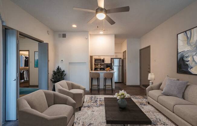 a living room and kitchen with a couch and a coffee table