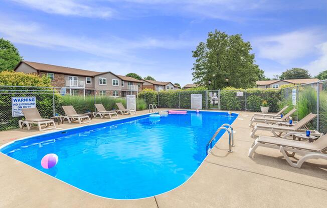 a group of lawn chairs sitting on top of a swimming pool