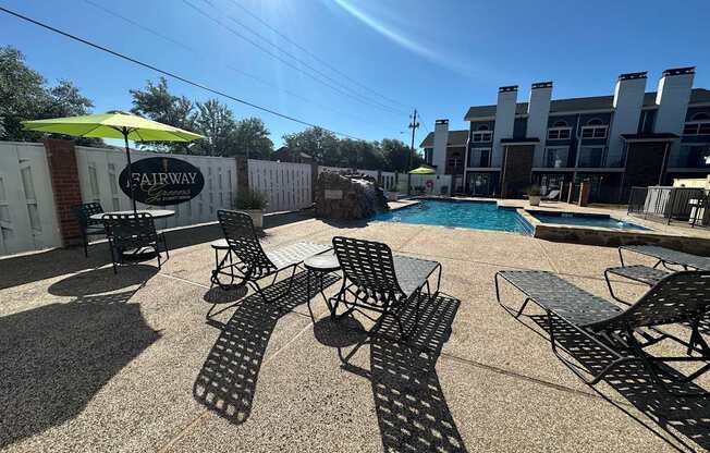 A pool area with chairs and a sign that says Fairway.