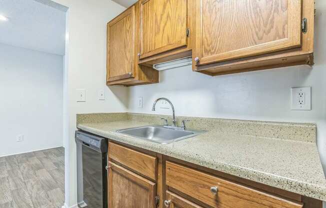 A kitchen with wooden cabinets and a granite countertop.