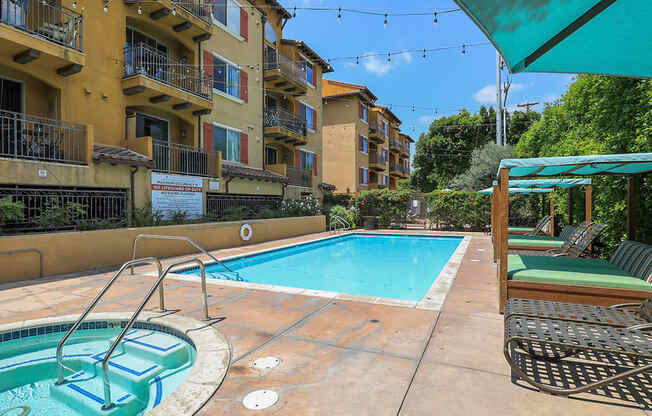 Swimming Pool with Cushioned Seating Areas at the verandas apartments near los angeles