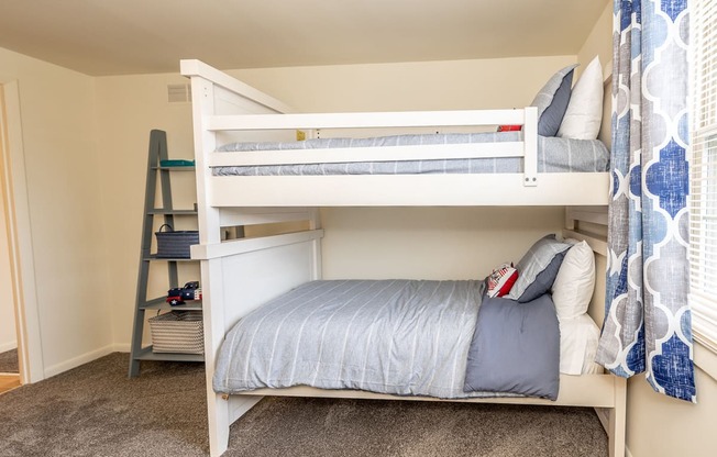 a bunk bed in a room with two bunk beds and a ladder at Chapel Valley Townhomes, Baltimore, 21236