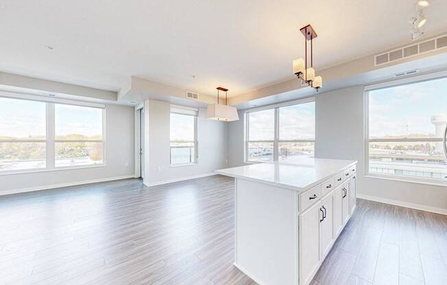 A spacious kitchen with white cabinets and a large island.