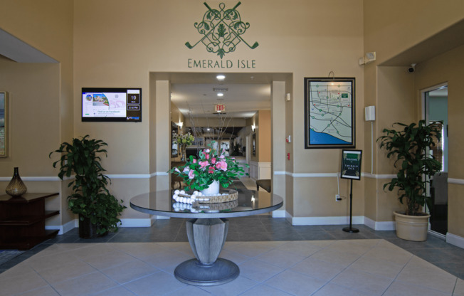 The lobby of Emerald Isle with a large table in the middle.,The lobby of Emerald Isle with a large table in the middle.