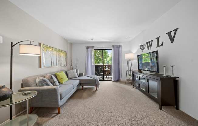 Cozy living room with natural light at Woodland Villa Apartments in Westland, MI.