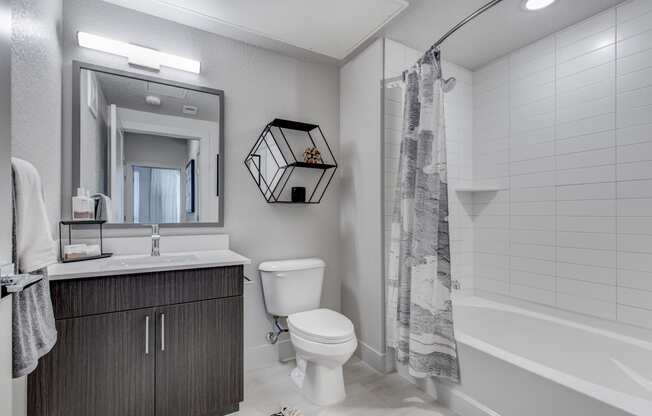 a bathroom with a toilet and a shower and a sink