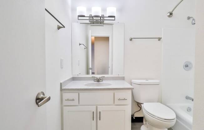 a bathroom with a sink toilet and a mirror