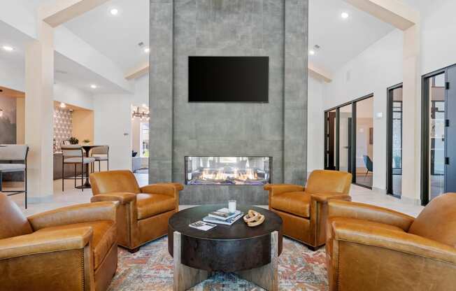 a living room filled with furniture and a large fireplace at The Lodge at Overland, Rochester, Minnesota