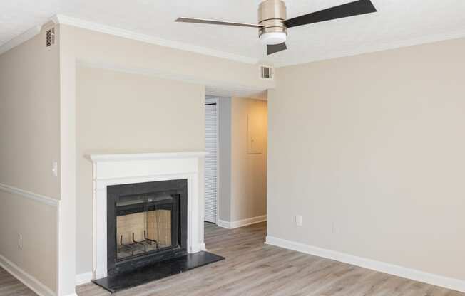Living space with fireplace and ceiling fan at Twin Springs, Norcross, GA