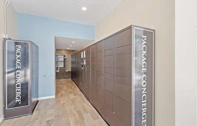 a communal elevator lobby in a building with wood floors and blue walls