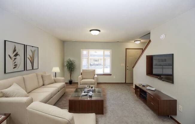 A living room with a couch, chair, and coffee table.