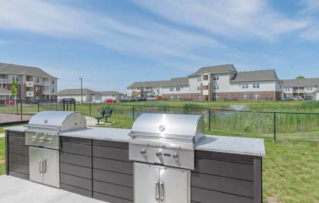 Community grill and bbq with a view of the apartments in the background