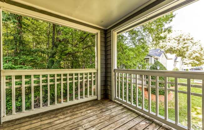 the screened porch has a view of the yard and the house