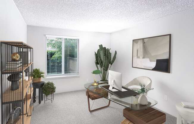 a living room with a glass desk with a computer on it