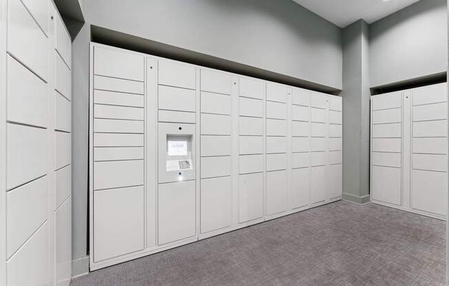 A row of white lockers in a room.
