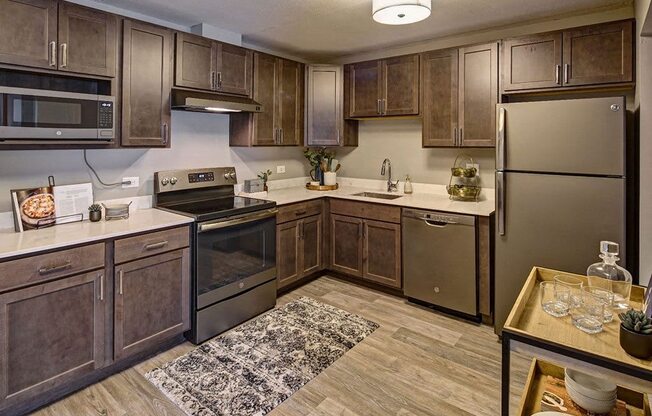 a kitchen with stainless steel appliances and wooden cabinets