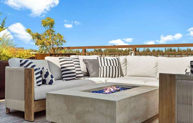 A modern outdoor seating area with a fire pit.