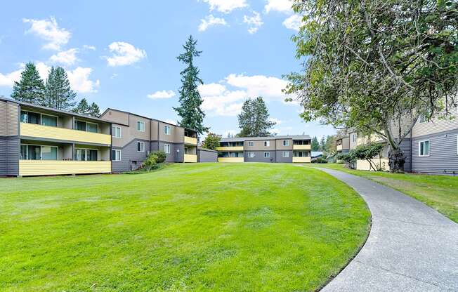 A grassy area in front of apartment buildings.