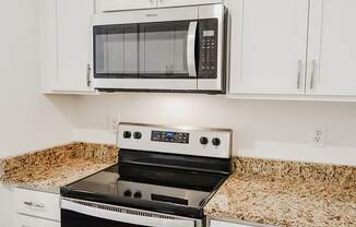 a kitchen with a stove and a microwave