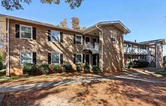 A large brick building with a balcony on the second floor.