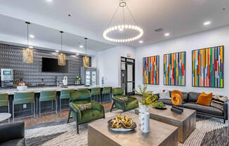 a living room with a kitchen and a table with chairs