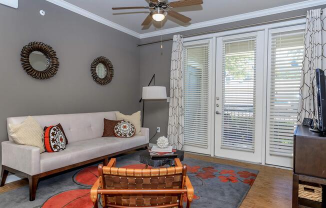 a living room filled with furniture and a large window