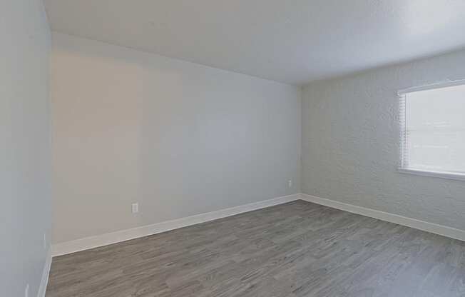 a bedroom with hardwood floors and a window at Allora Phoenix Apartments, Arizona, 85021