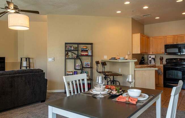 A modern dining room with a table set for two.