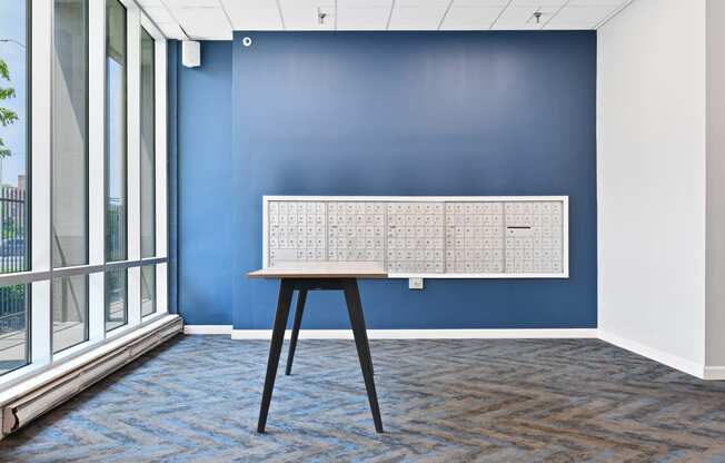 a conference room with blue walls and a table with a white board on the wall