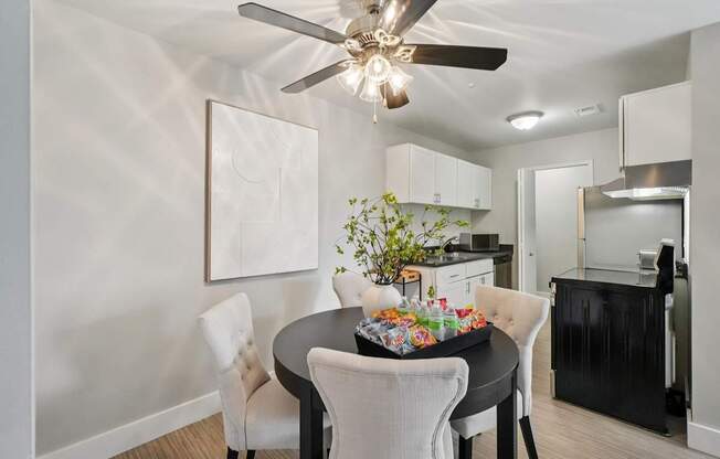 A dining room with a table set for a meal.