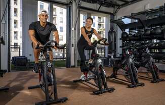 two men working out on exercise bikes in a gymat AVE Phoenix Sky, Phoenix, AZ, Arizona , 85003