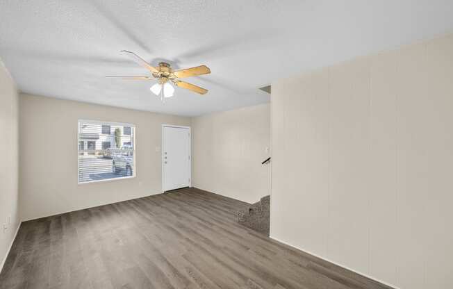 a spacious living room with white walls and a ceiling fan at Brookside Apartments, Hewitt, 76643