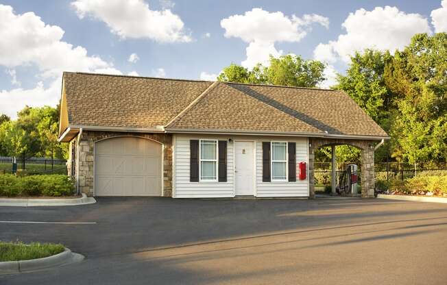 a white garage with a white door and a brown roof