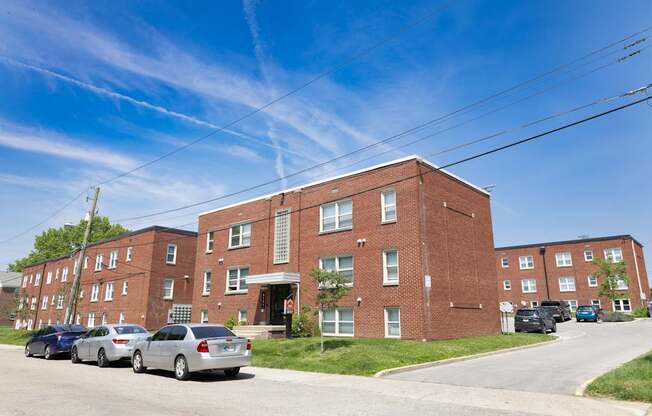 Street view of Monon Court’s red brick apartment buildings along Compton Street near E 61st in Broad Ripple, Indianapolis