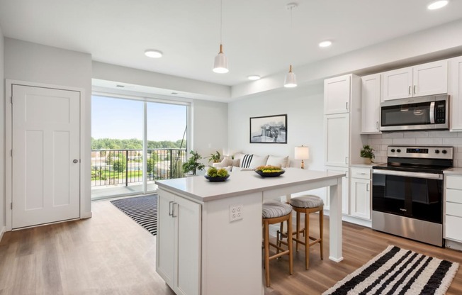 an open kitchen with a large island with two stools