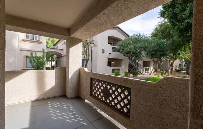 A balcony with a lattice design in the middle of it.