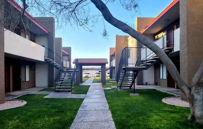 a walkway between two buildings on a sunny day