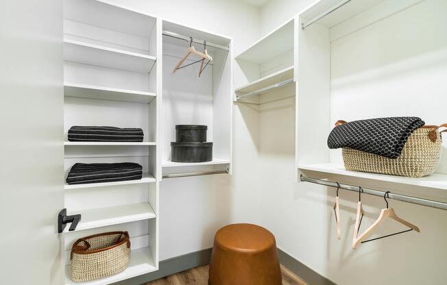 A spacious closet with built-in shelving and plenty of room to organize.