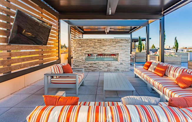 Rooftop lounge seating with TV and fireplace at Bayswater Apartments, California