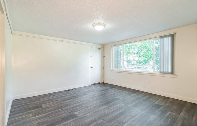 Living room with wood style flooring at Sutterfield Apartments in Providence RI