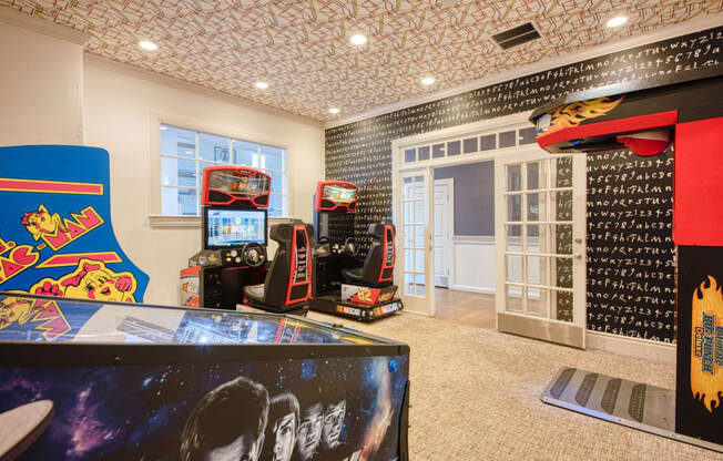 the game room has a lot of video games at Residences at Stevens Pond, Saugus, MA