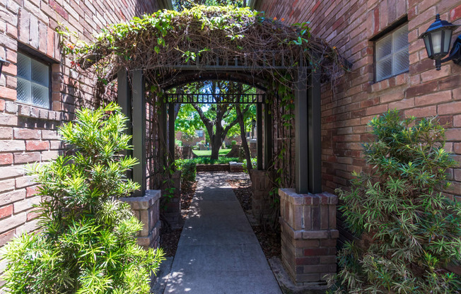 This is a photo of the the entrance to the courtyard at The Brownstones Townhome Apartments in Dallas, TX.