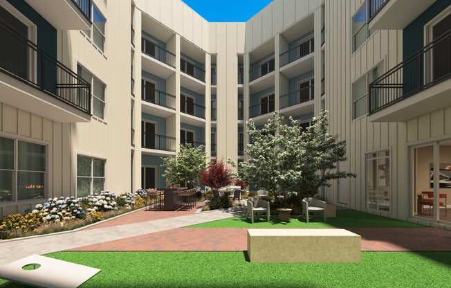a rendering of a courtyard in a building with green grass and trees at Tiffany Flats, Columbus
