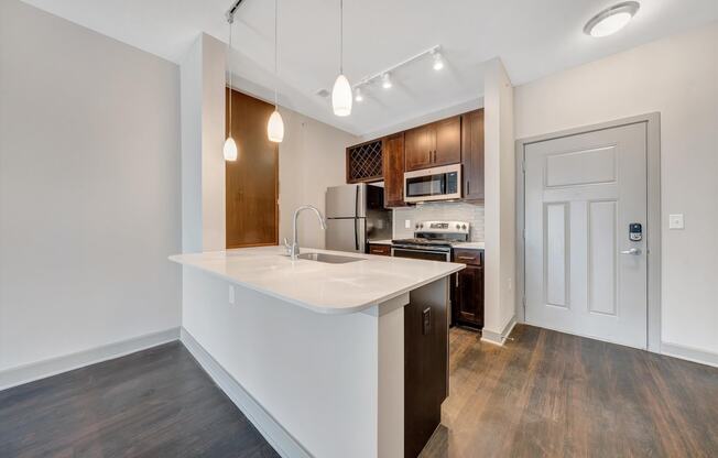 a kitchen with a white counter top and