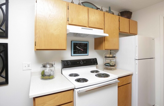 Kitchen area with stove, oven, fridge, and freezer