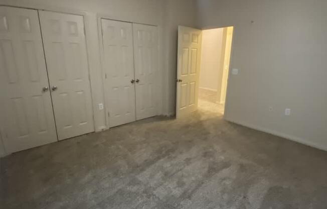 an empty room with a ceiling fan in it