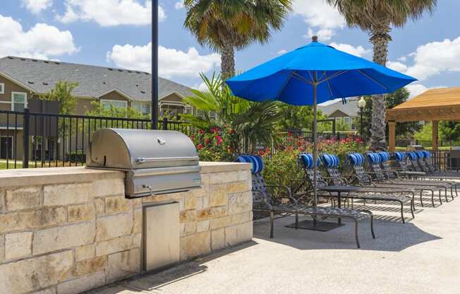 poolside lounge chairs and grilling station